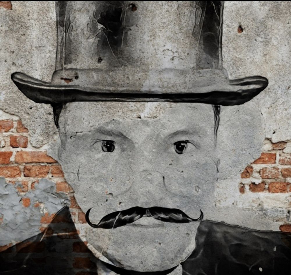 Monsieur A.C.: a street-art portrait of a man in a top hat with a curled handlebar moustache, painted on a crumbling plaster and brick wall